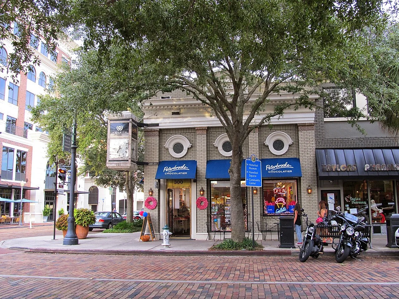 Storefronts and shaded sidewalk along Park Avenue in Winter Park