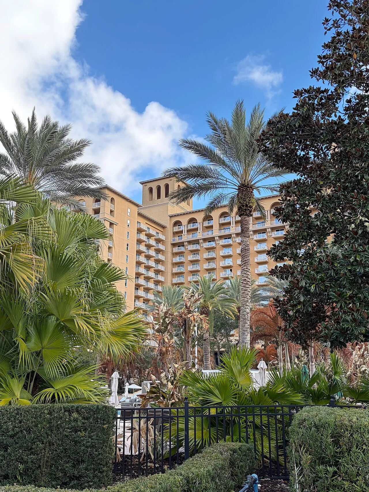 The Ritz-Carlton Orlando, Grande Lakes framed by palms and gardens